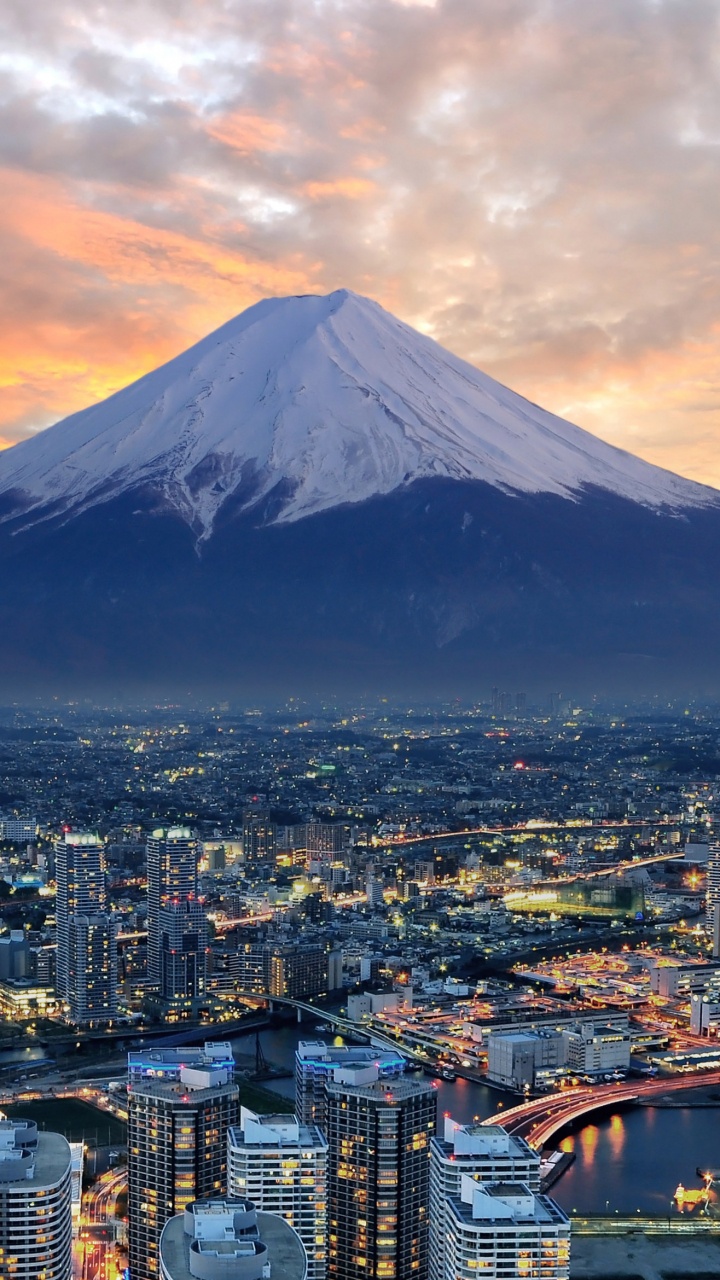 Aerial View of City Buildings Near Snow Covered Mountain During Daytime. Wallpaper in 720x1280 Resolution
