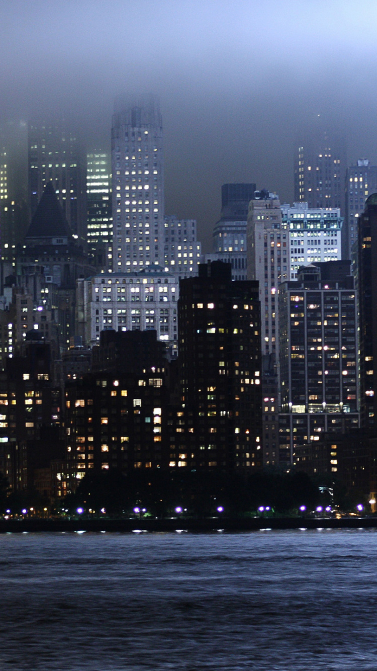 City Skyline Across Body of Water During Night Time. Wallpaper in 750x1334 Resolution