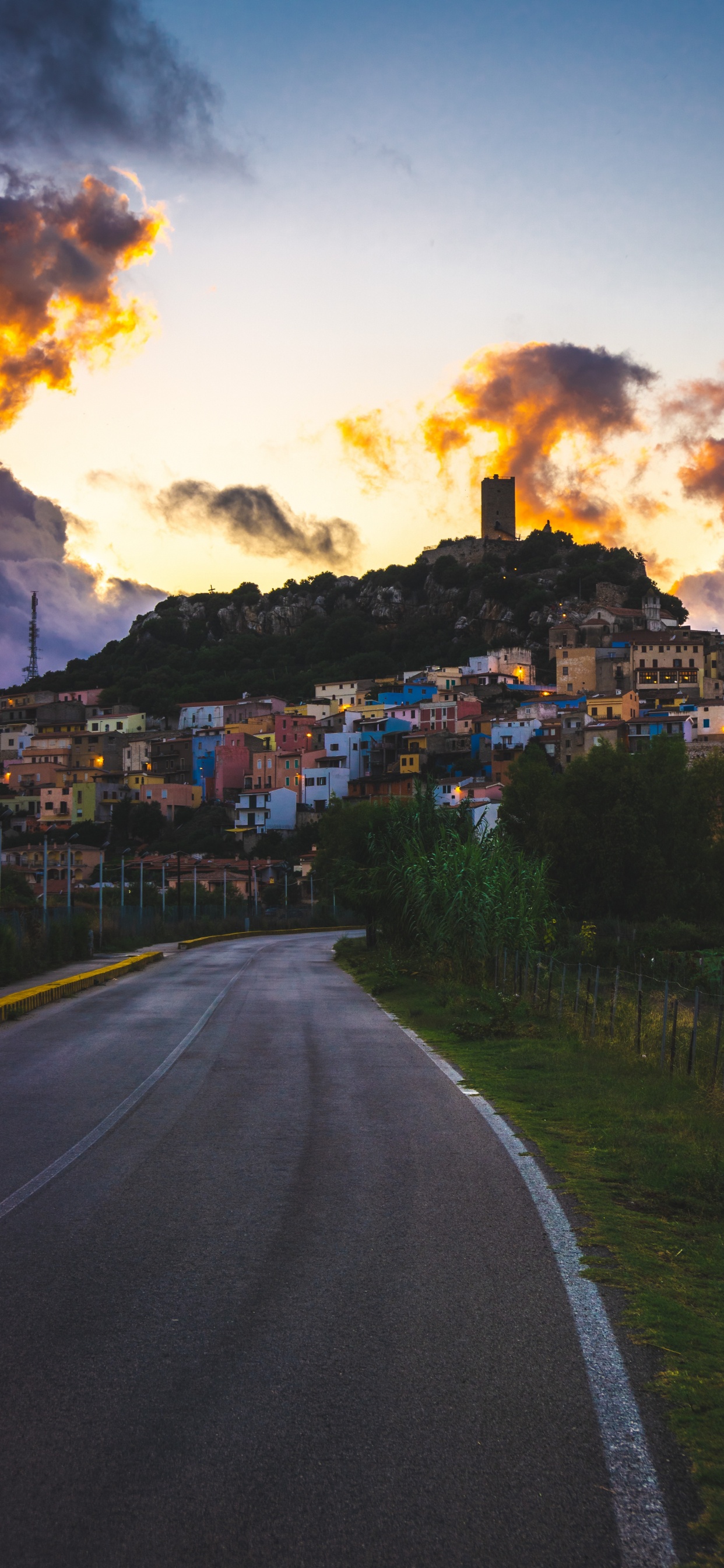Gray Concrete Road Near Houses Under White Clouds. Wallpaper in 1242x2688 Resolution