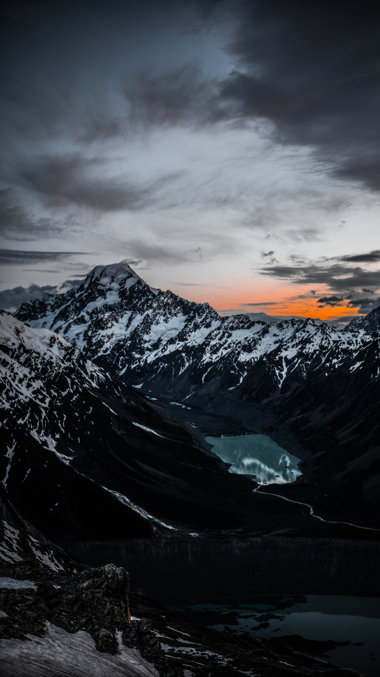Snow Covered Mountain Under Cloudy Sky During Daytime. Wallpaper in 750x1334 Resolution