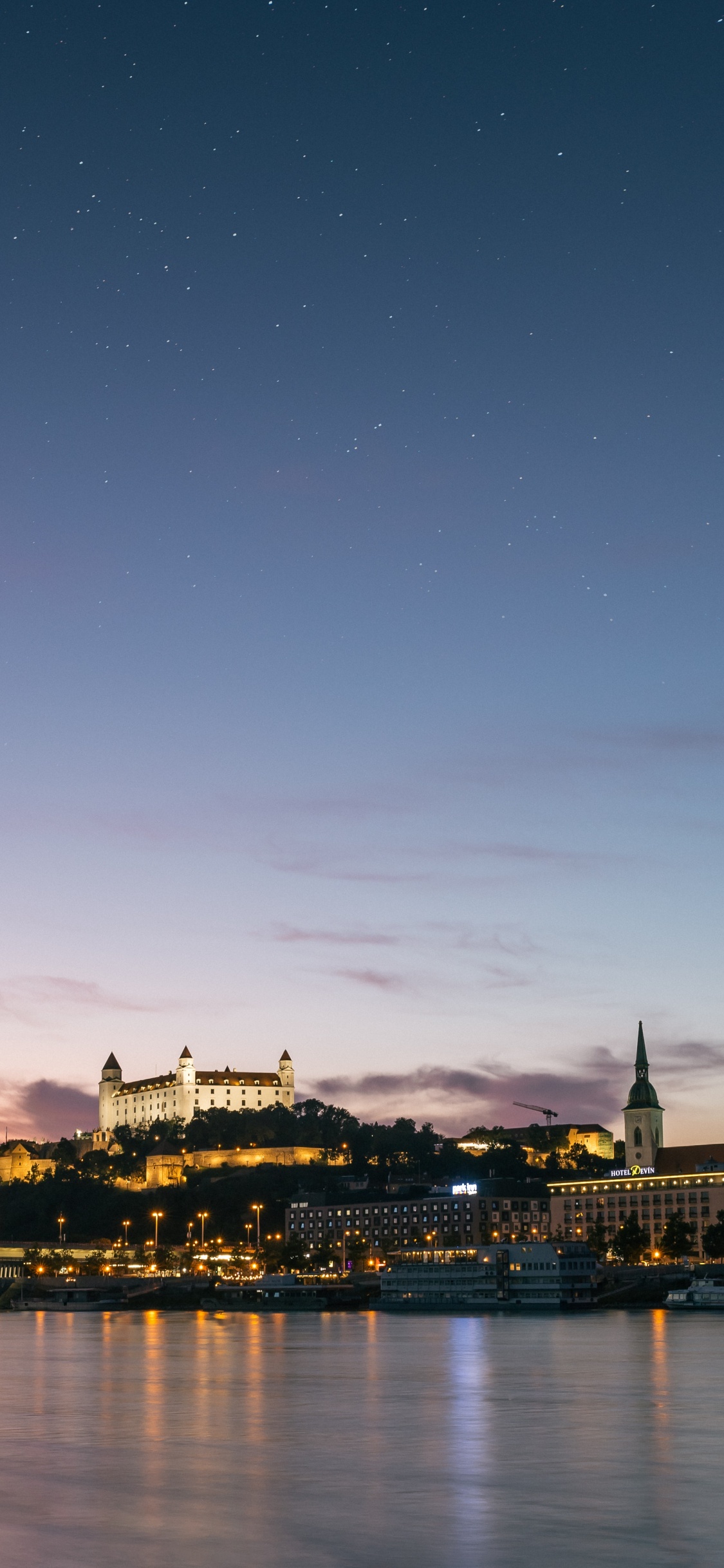 City Skyline During Night Time. Wallpaper in 1125x2436 Resolution