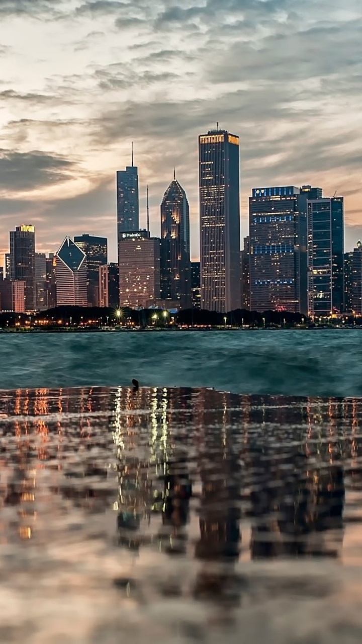 City Skyline Across Body of Water During Daytime. Wallpaper in 720x1280 Resolution