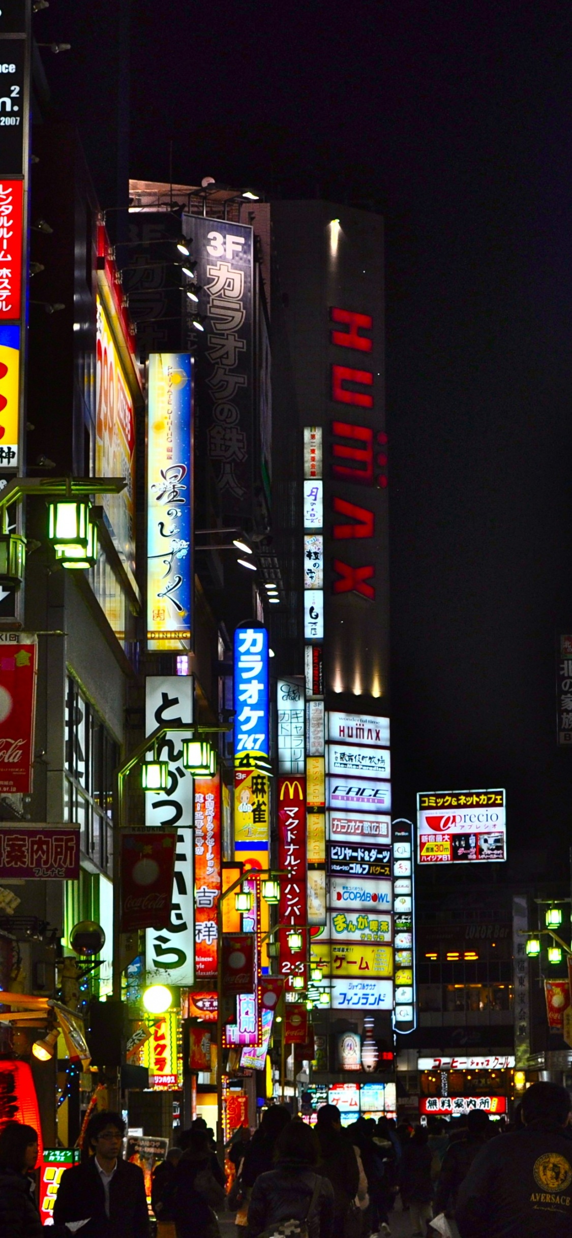 People Walking on Street During Nighttime. Wallpaper in 1125x2436 Resolution