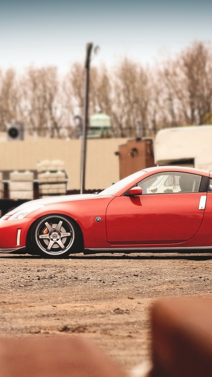 Red Ferrari Coupe Parked on Brown Field During Daytime. Wallpaper in 720x1280 Resolution