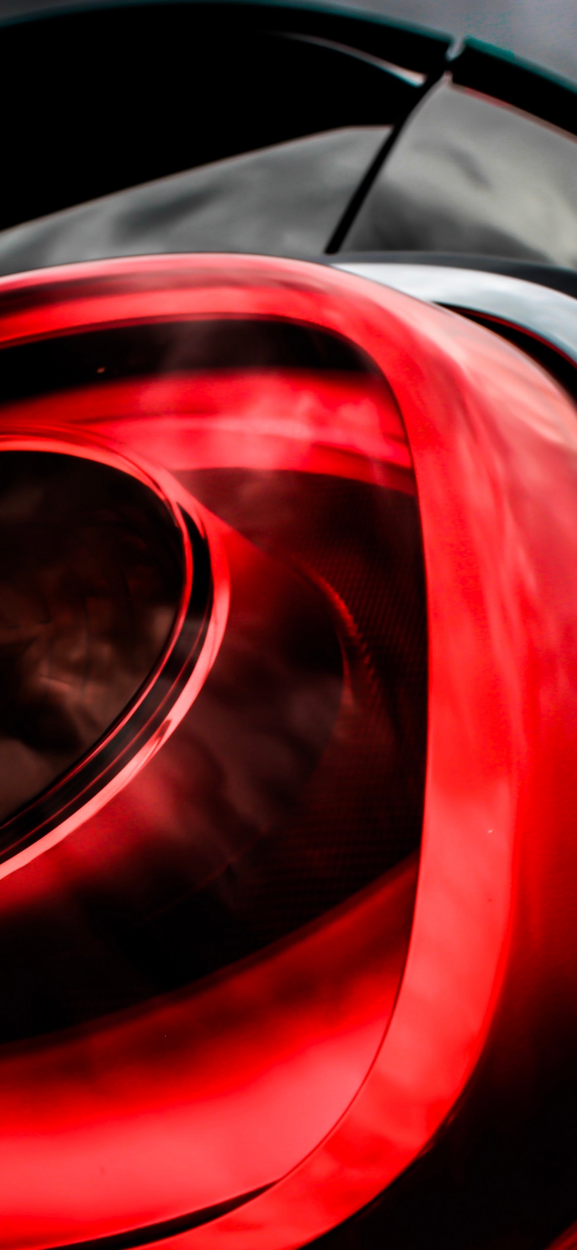 Red and Black Car Side Mirror. Wallpaper in 1125x2436 Resolution