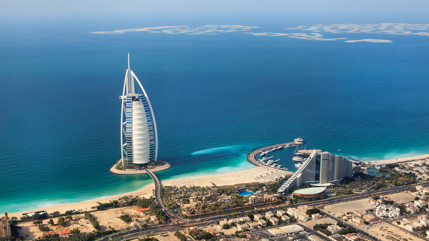 White and Blue Building Near Body of Water During Daytime. Wallpaper in 1366x768 Resolution