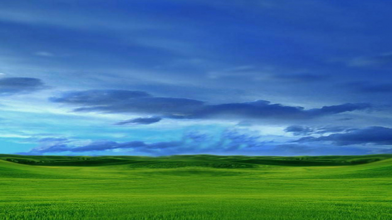 Green Grass Field Under Cloudy Sky During Daytime. Wallpaper in 1366x768 Resolution