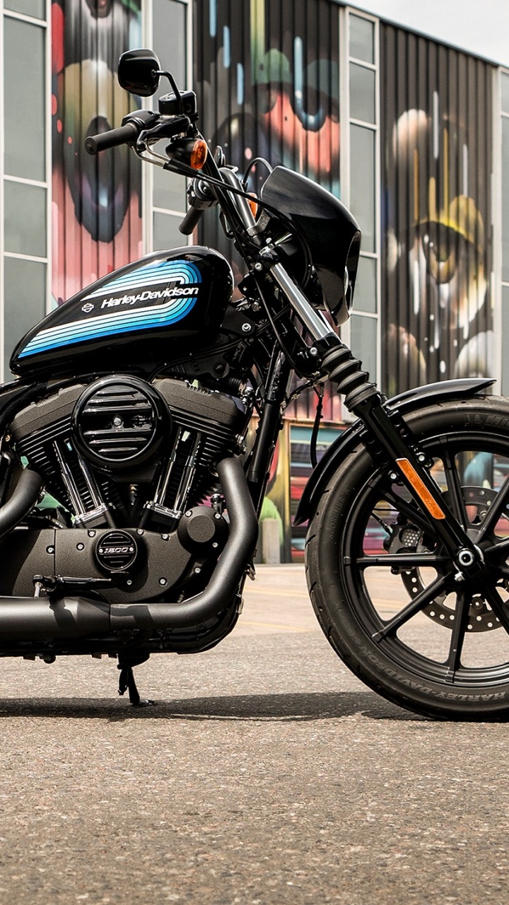 Black and Blue Naked Motorcycle Parked Beside Wall. Wallpaper in 720x1280 Resolution