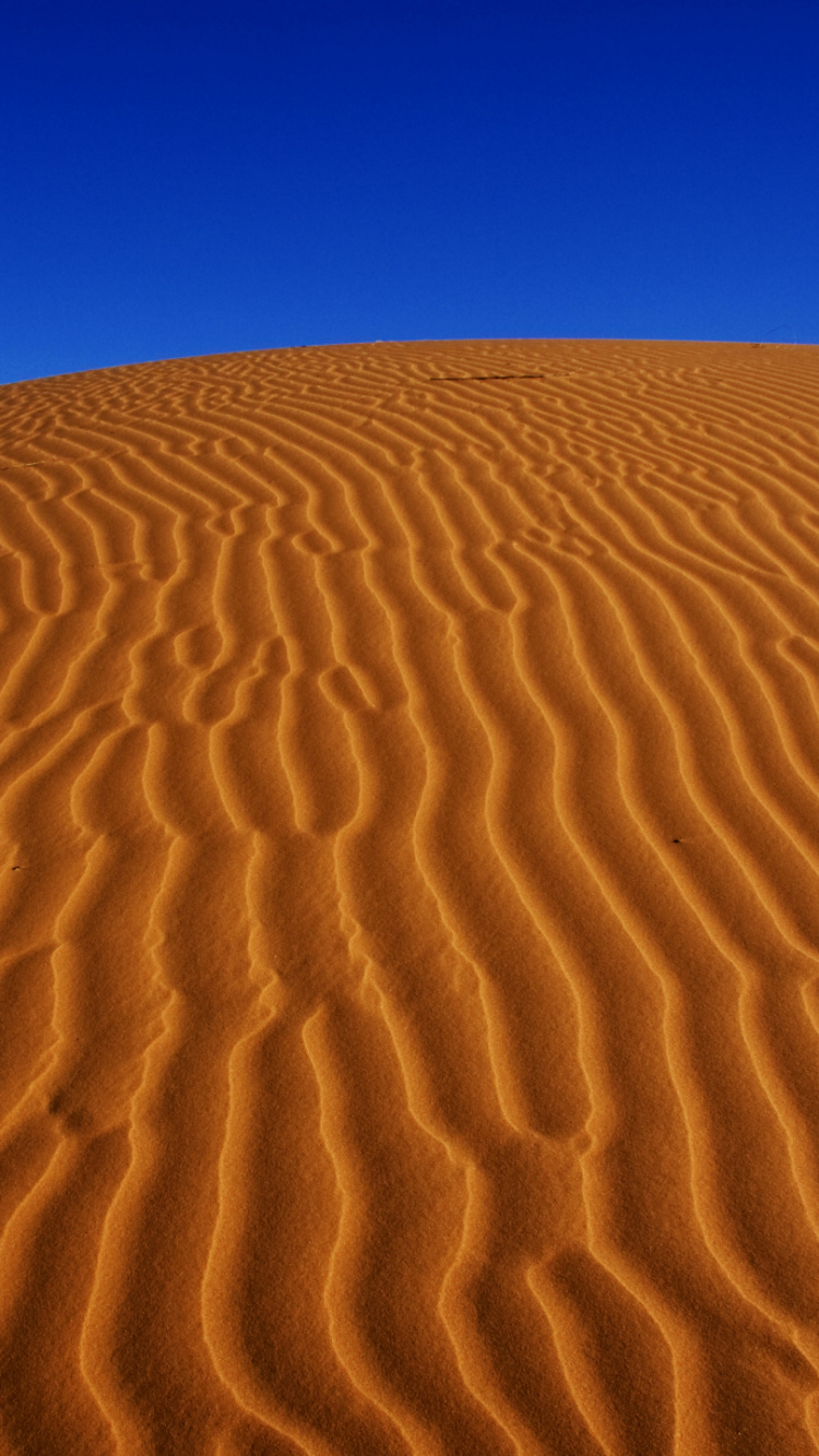 Brown Sand Under Blue Sky During Daytime. Wallpaper in 750x1334 Resolution