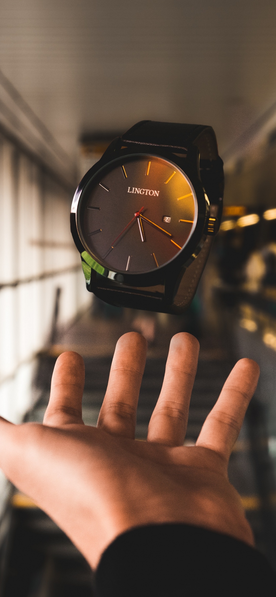 Person Wearing Black and Green Analog Watch. Wallpaper in 1125x2436 Resolution