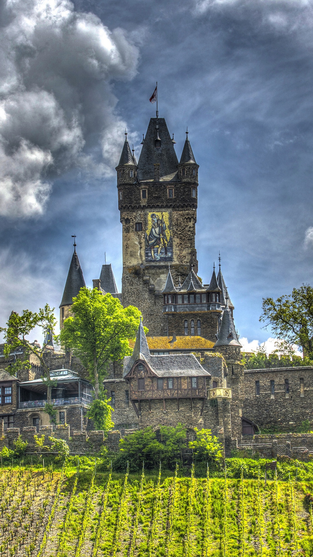 Green and Yellow Castle Under Cloudy Sky. Wallpaper in 1080x1920 Resolution