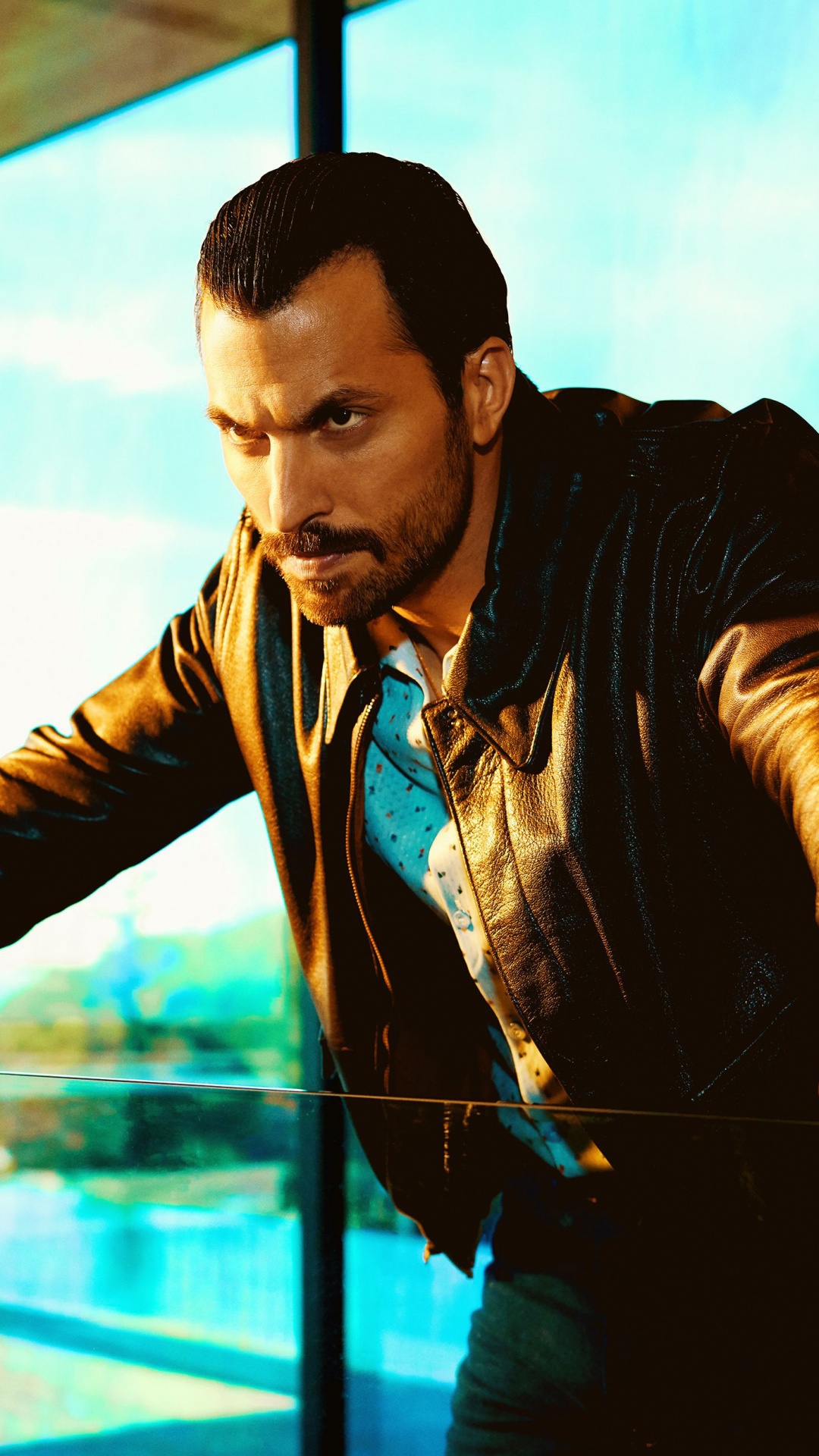 Man in Black Leather Jacket Standing Beside Glass Window. Wallpaper in 1080x1920 Resolution