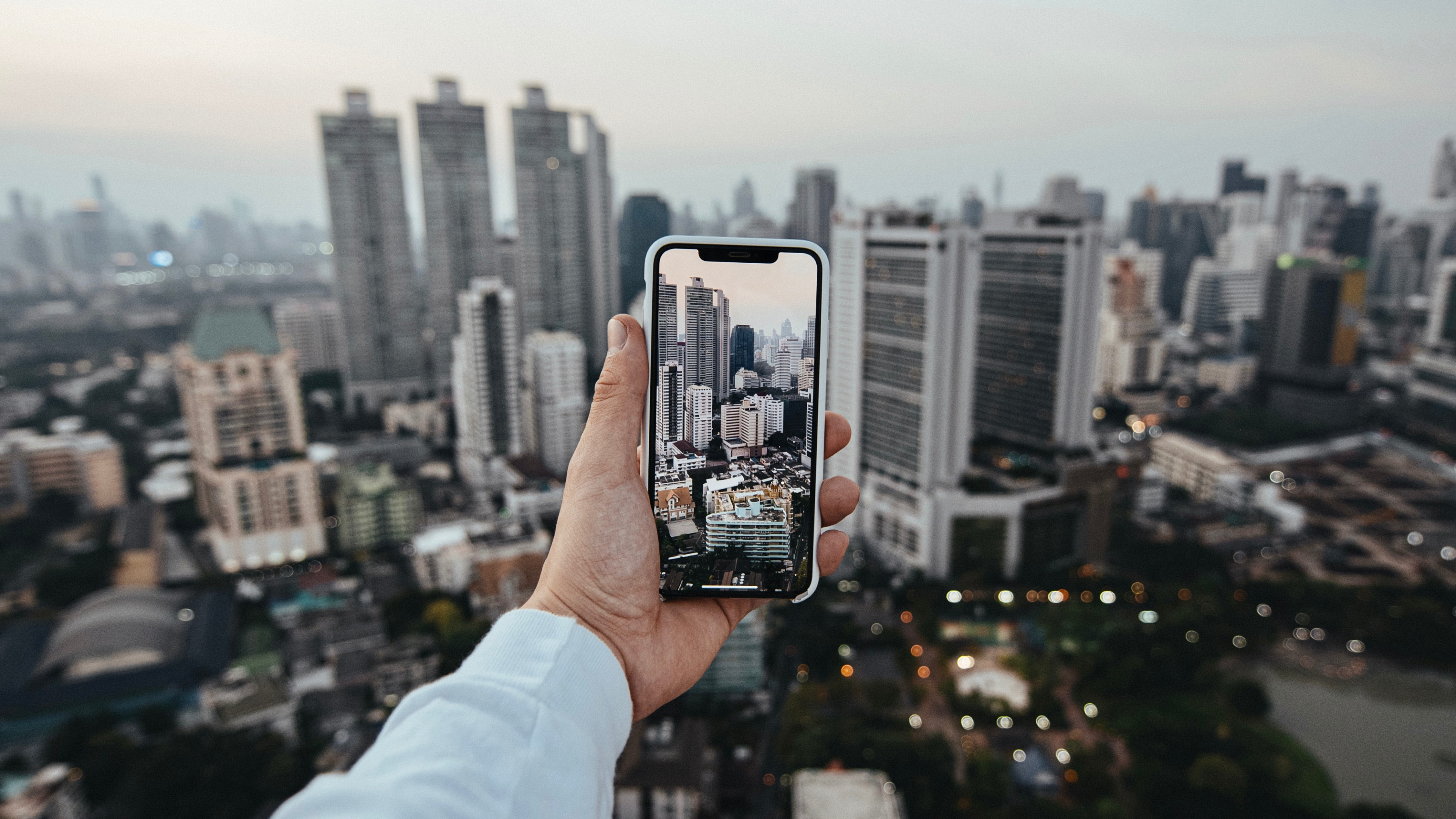 Person Holding Black Smartphone Taking Photo of City Buildings During Daytime. Wallpaper in 3840x2160 Resolution