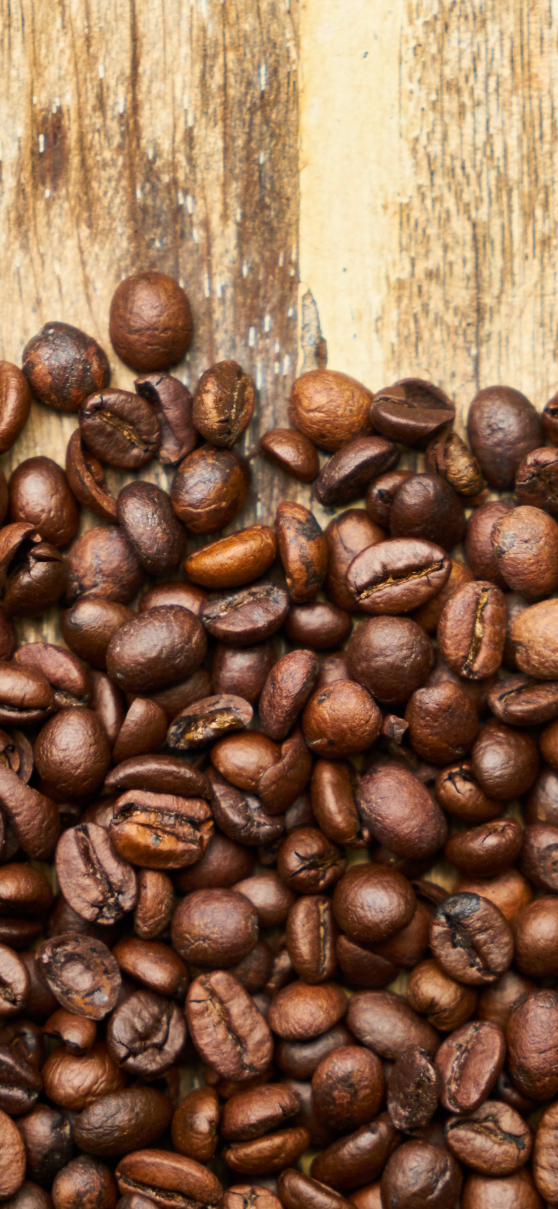 Coffee Beans on Brown Wooden Table. Wallpaper in 1125x2436 Resolution