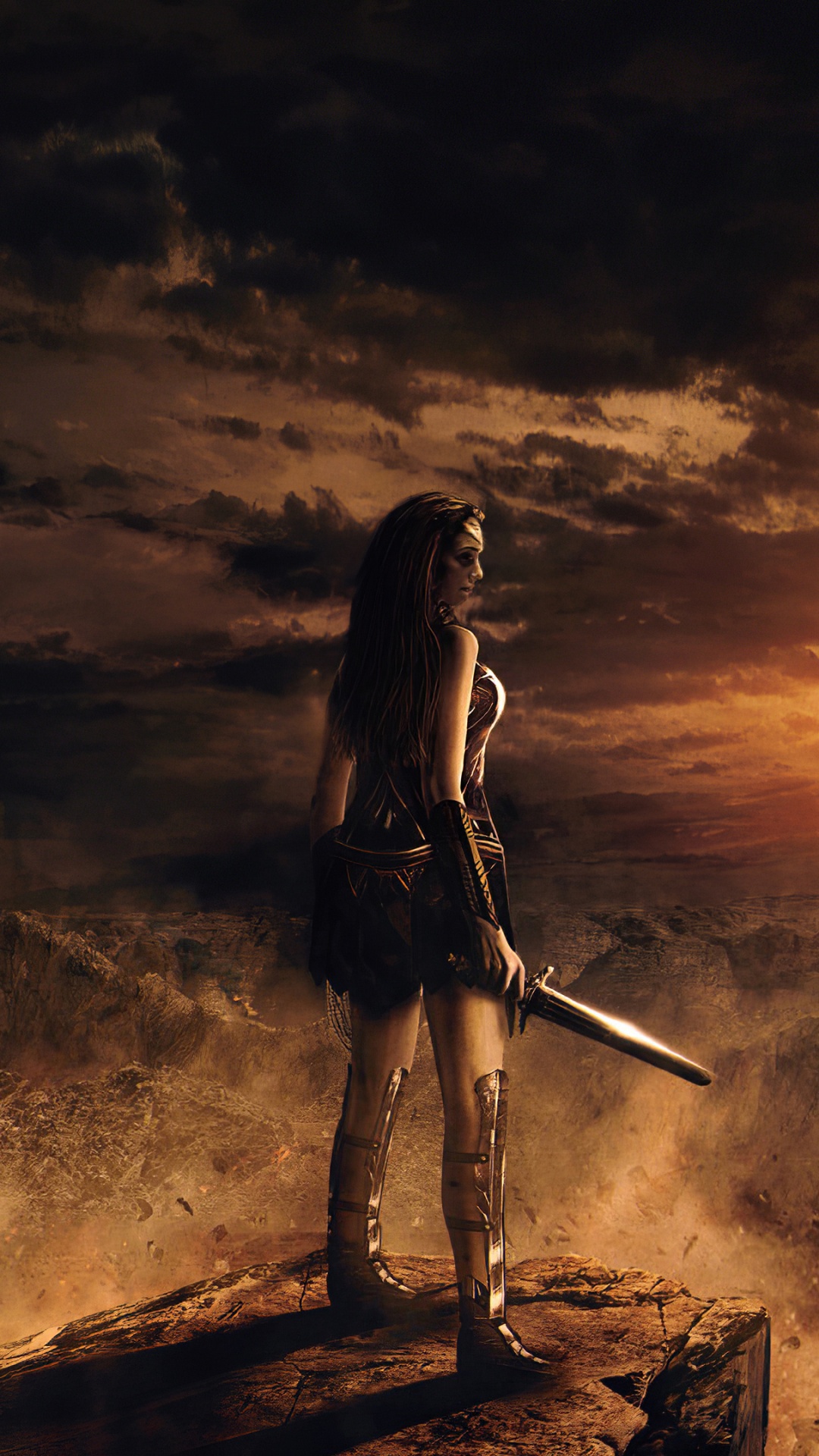 Femme en Veste et Pantalon Noirs Tenant un Bâton Debout Sur Une Bûche de Bois Marron Pendant le Coucher du Soleil. Wallpaper in 1080x1920 Resolution