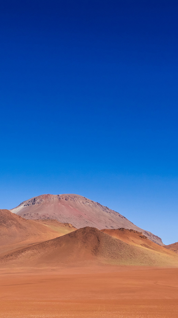 Brown Mountain Under Blue Sky During Daytime. Wallpaper in 750x1334 Resolution