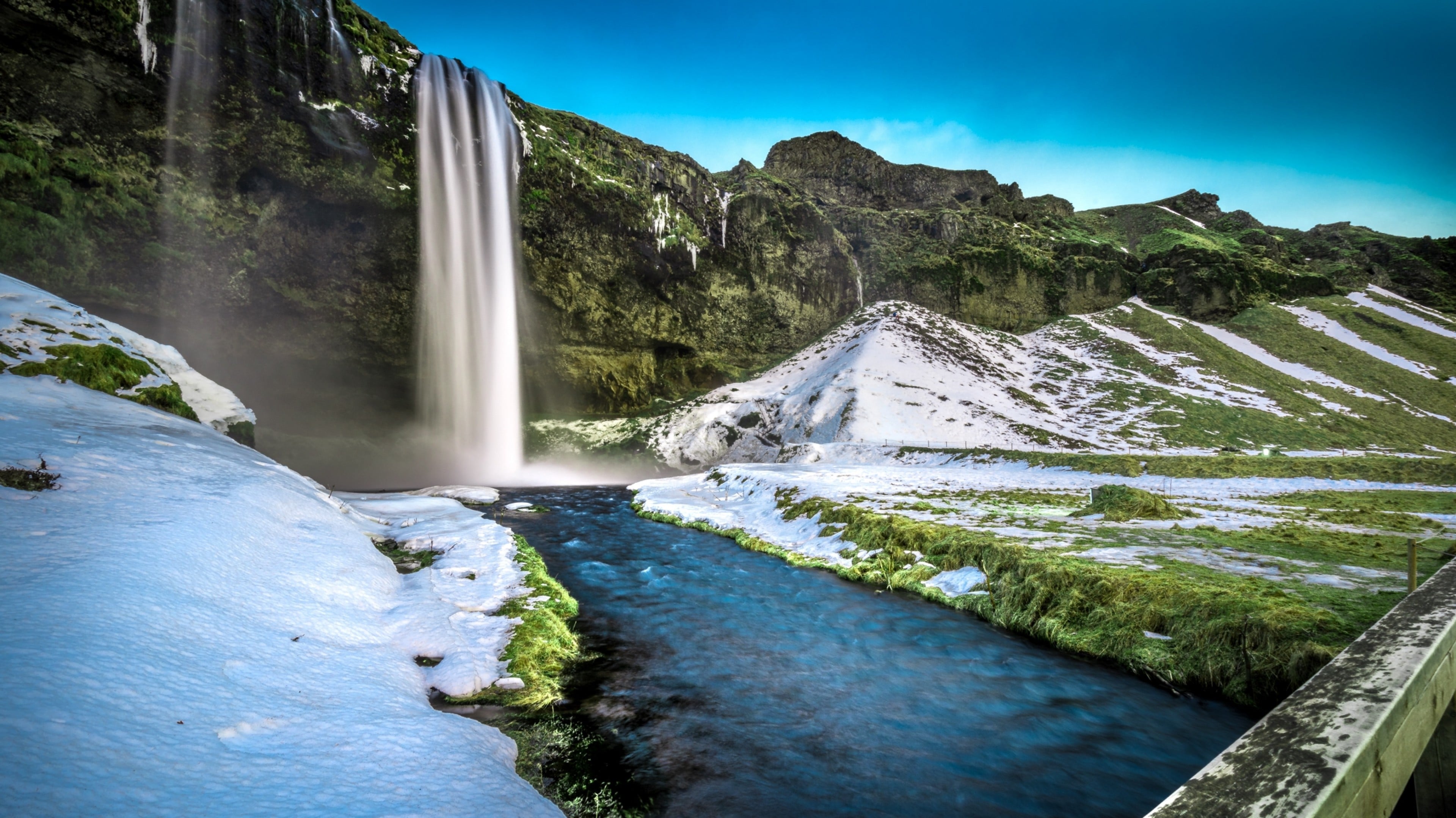 Wallpaper Waterfalls Near Green and Gray Mountain Under Blue