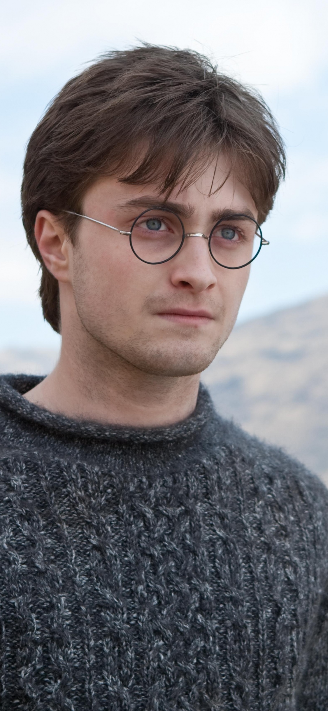 Man in Gray Sweater Wearing Black Framed Eyeglasses. Wallpaper in 1125x2436 Resolution