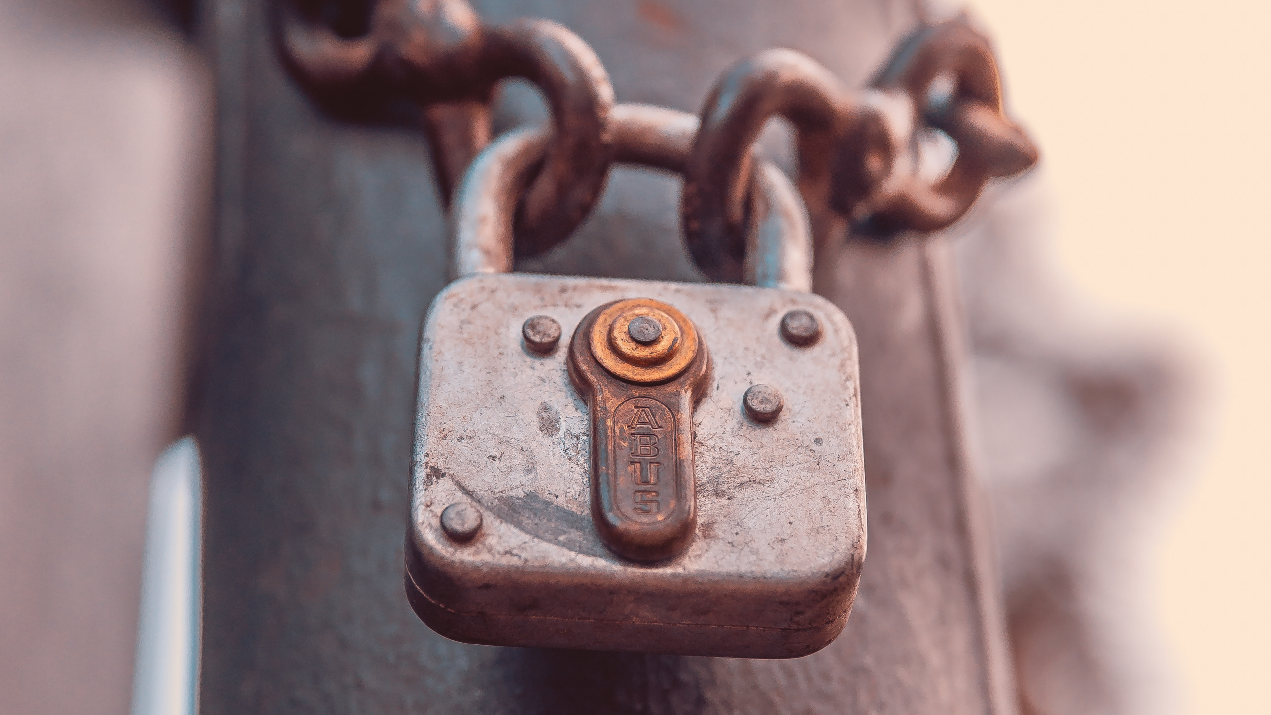 Brown Padlock on Black Metal Bar. Wallpaper in 2560x1440 Resolution