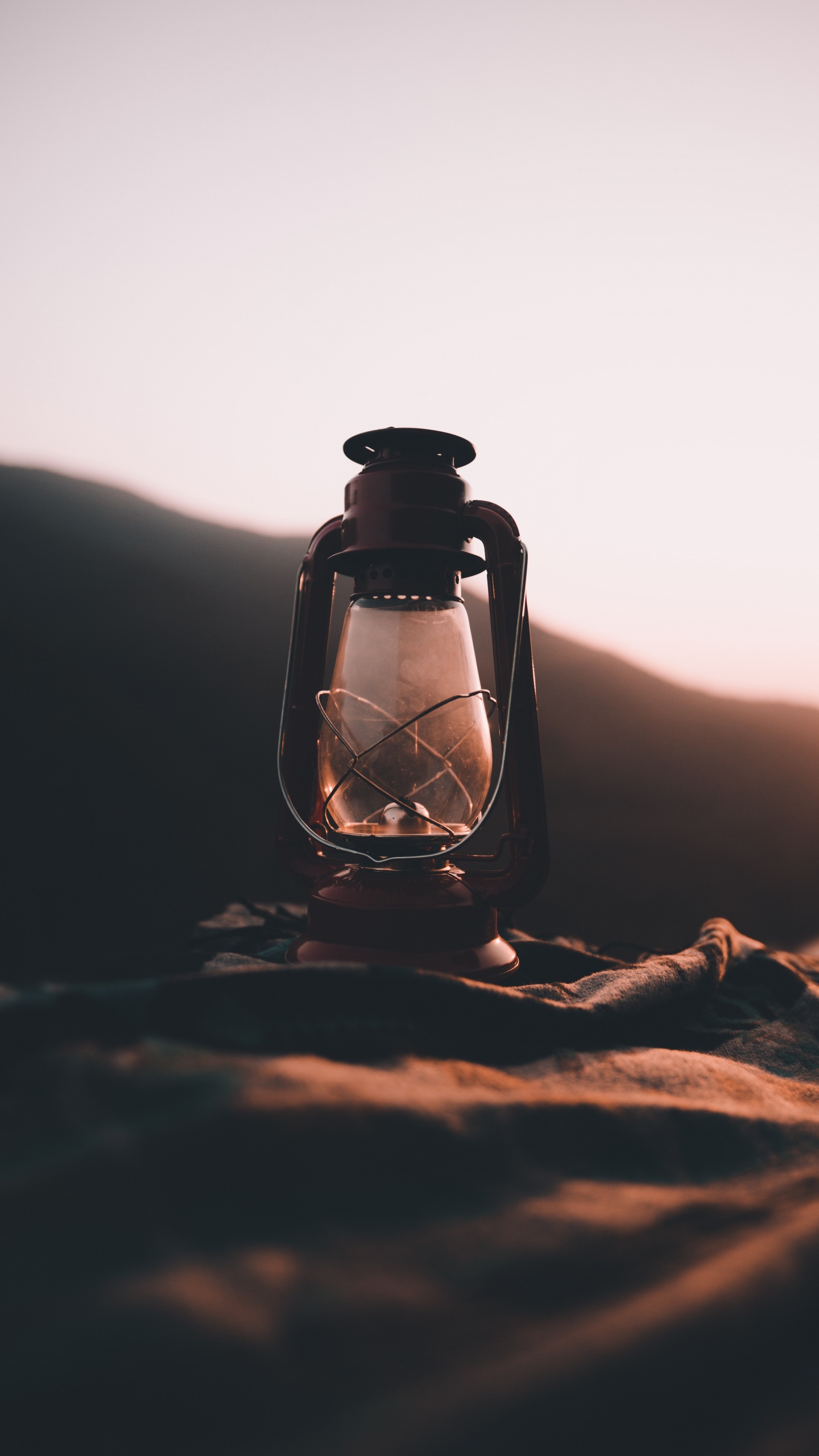 Clear Glass Bottle on Brown Sand. Wallpaper in 1440x2560 Resolution