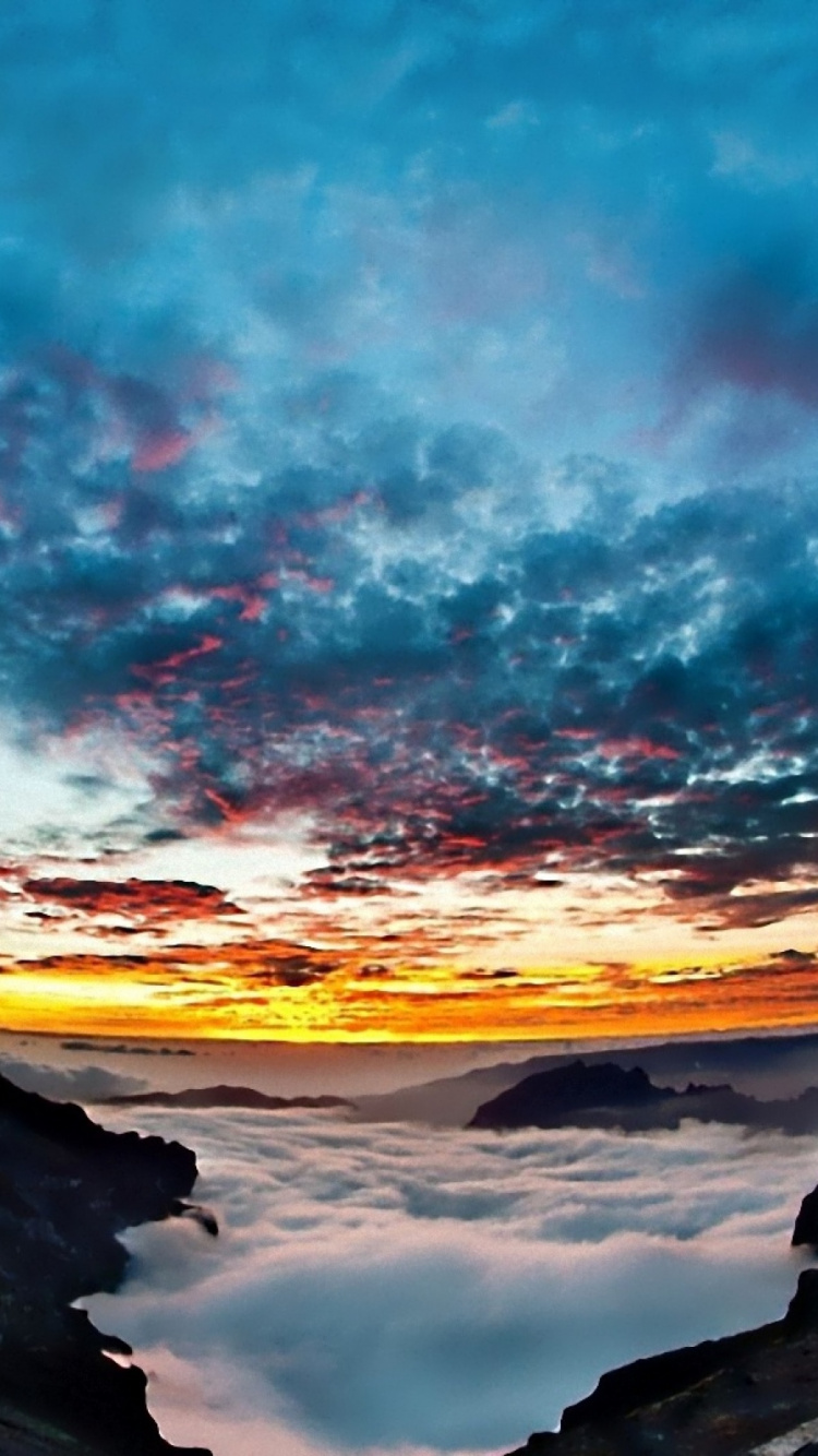 Blue and White Sky Over Rocky Mountain. Wallpaper in 750x1334 Resolution
