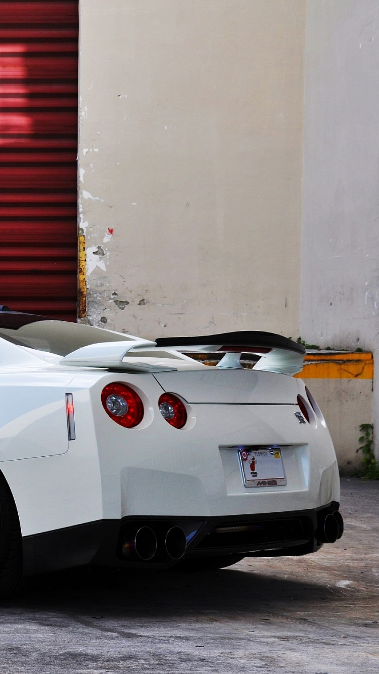 White Porsche 911 Parked Near Red Roll up Door. Wallpaper in 750x1334 Resolution