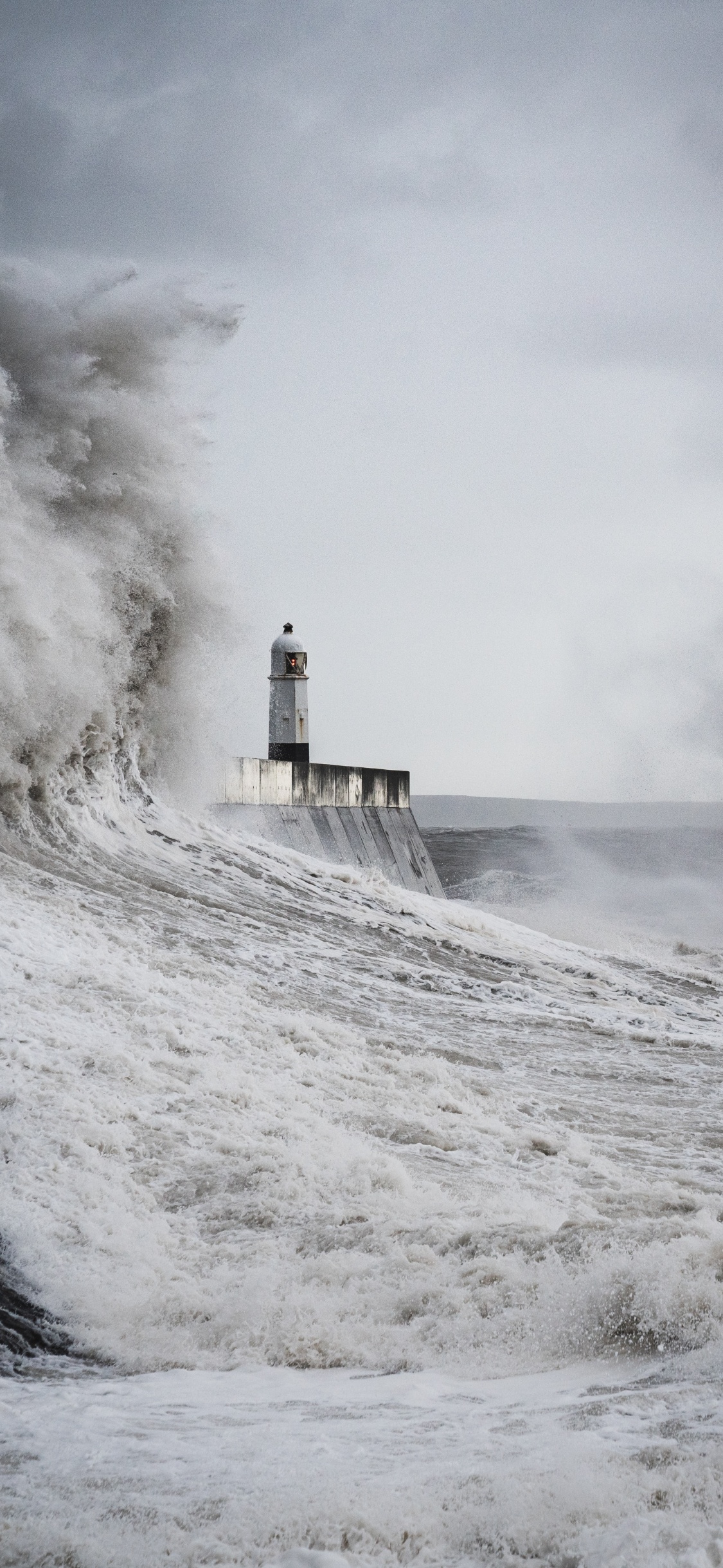 White and Black Lighthouse on White Snow Covered Ground During Daytime. Wallpaper in 1125x2436 Resolution