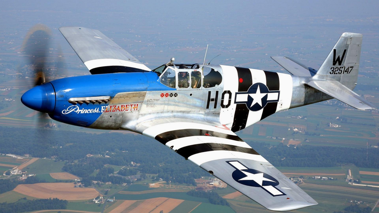 Avion à Réaction Bleu et Orange Survolant la Ville Pendant la Journée. Wallpaper in 1280x720 Resolution