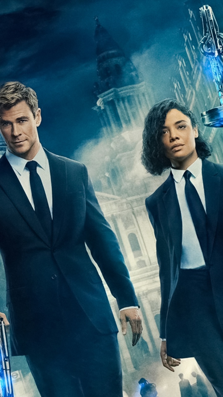 Man in Black Suit Jacket Standing Beside Woman in Black Blazer. Wallpaper in 720x1280 Resolution