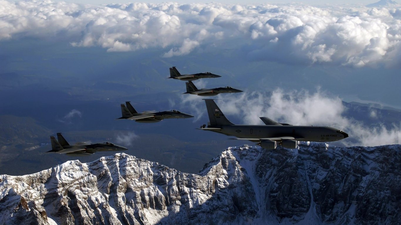 Black Fighter Plane Flying Over Snow Covered Mountain During Daytime. Wallpaper in 1366x768 Resolution
