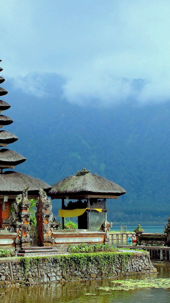 Brown and Green Temple Near Body of Water During Daytime. Wallpaper in 720x1280 Resolution