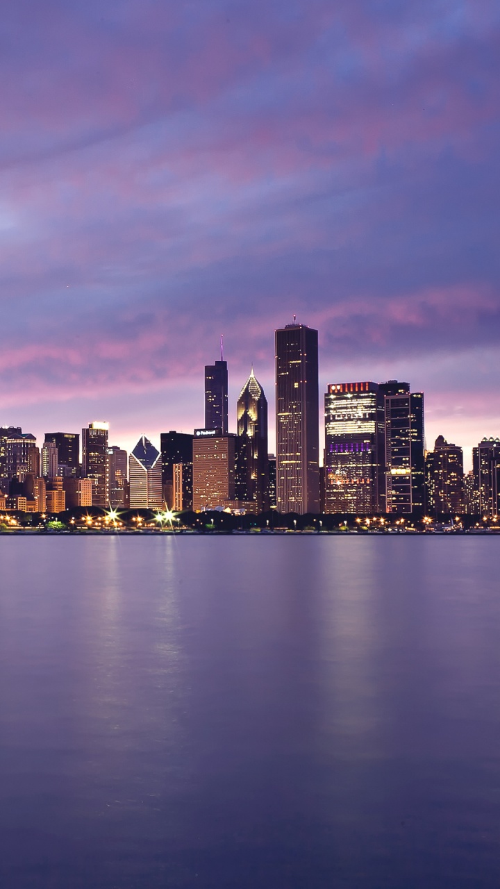 City Skyline Across Body of Water During Night Time. Wallpaper in 720x1280 Resolution