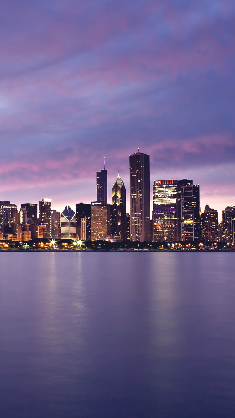 City Skyline Across Body of Water During Night Time. Wallpaper in 750x1334 Resolution