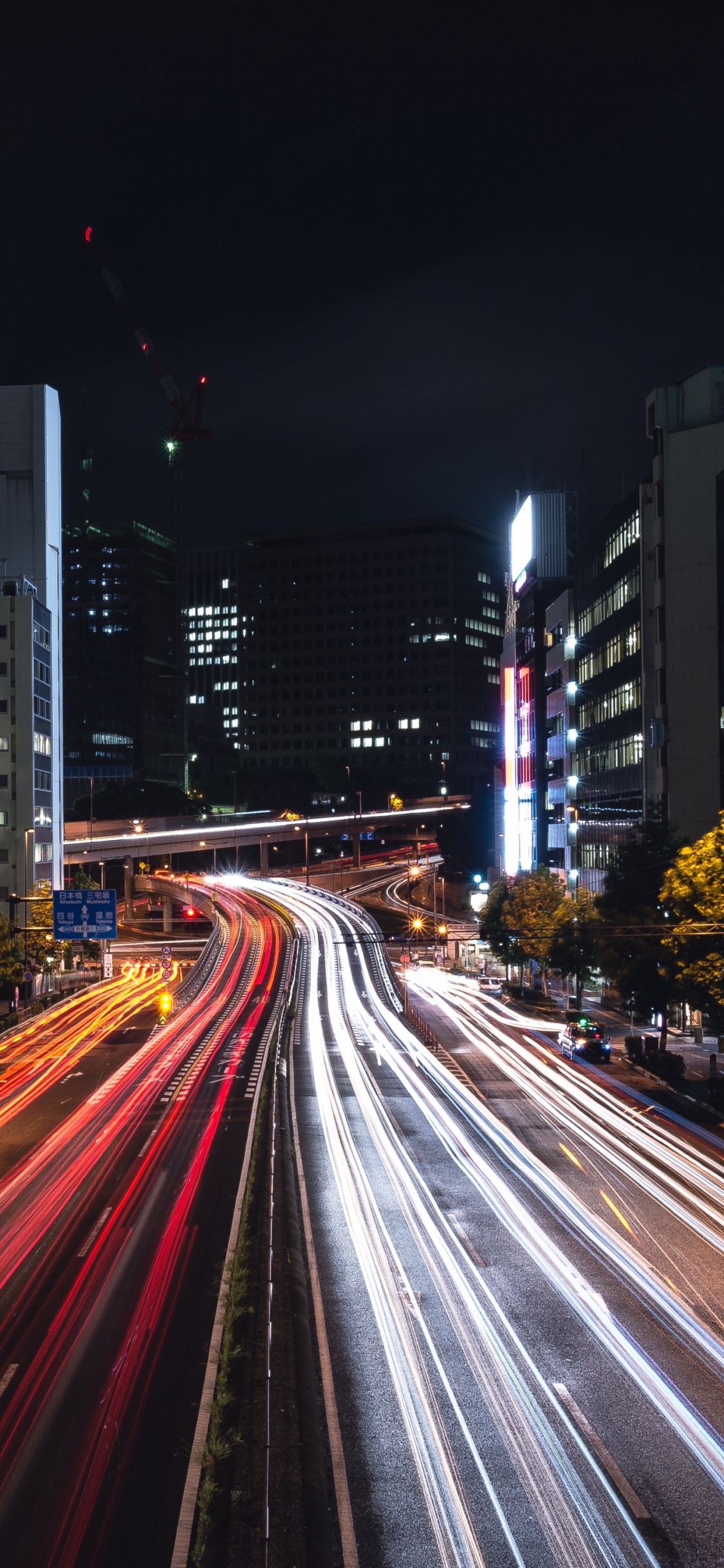 Time Lapse Photography of City Road During Night Time. Wallpaper in 1125x2436 Resolution