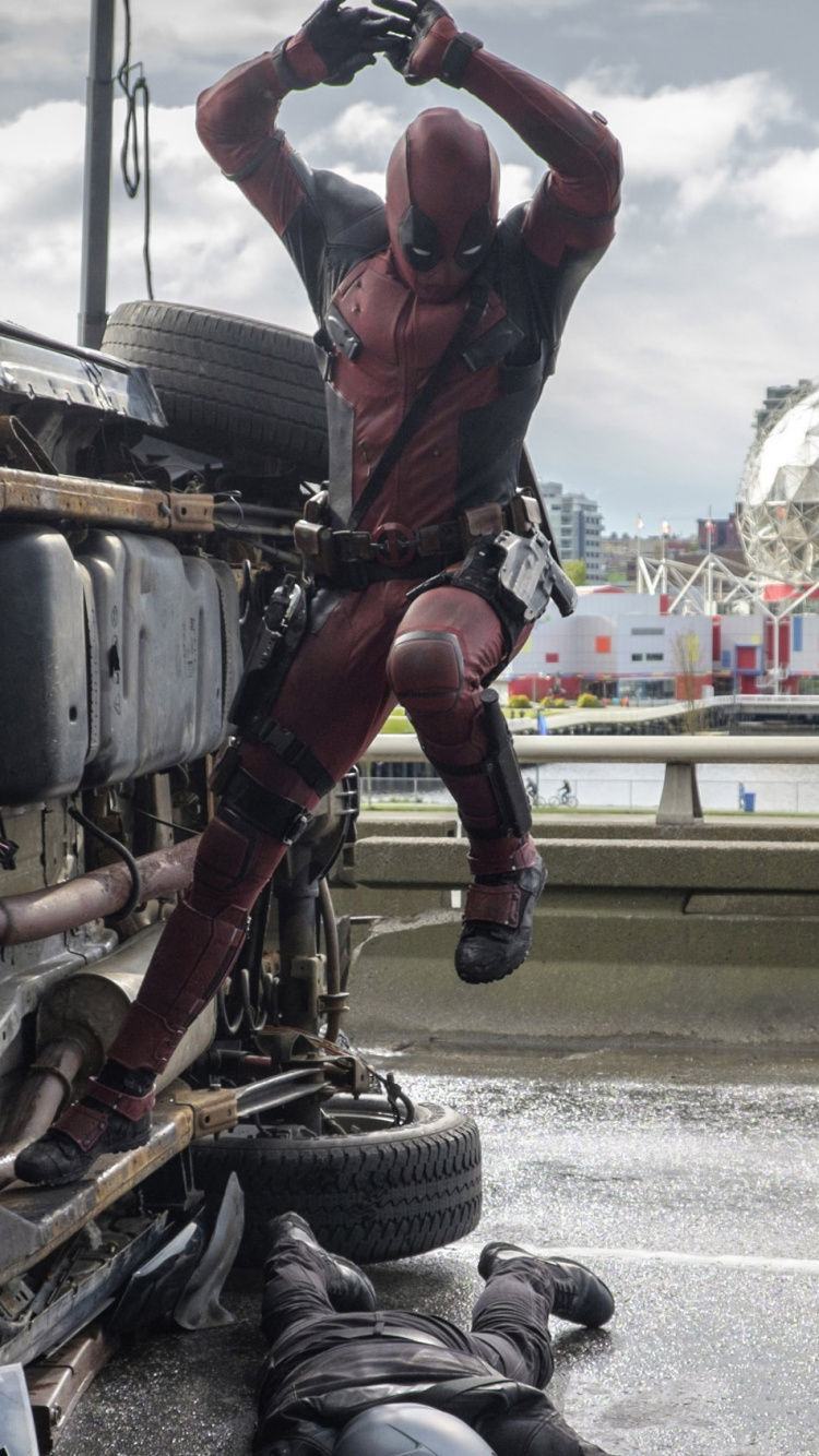 Man in Red T-shirt and Black Pants Wearing Black Boots Standing on Gray and Black. Wallpaper in 750x1334 Resolution