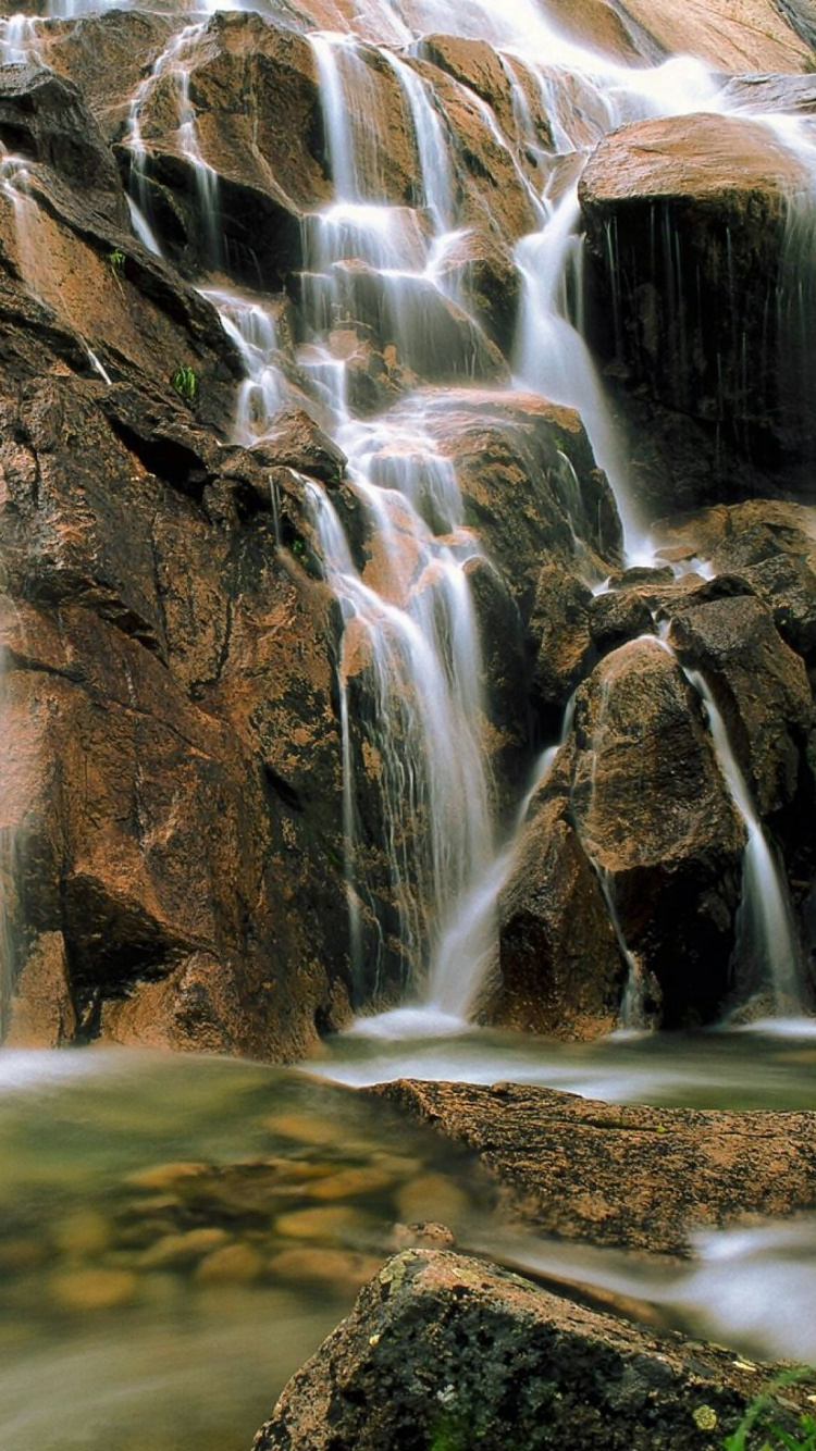 Water Falls on Brown Rocky Mountain. Wallpaper in 750x1334 Resolution