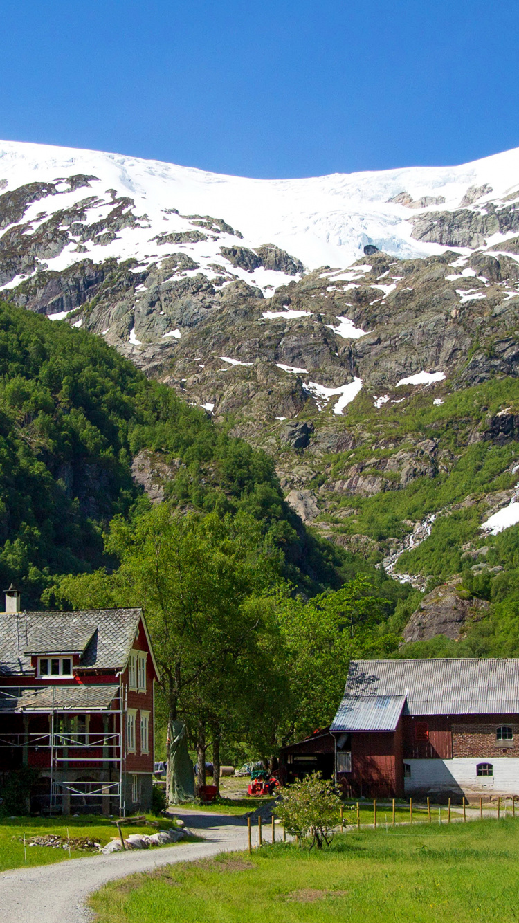 Red and White House Near Green Trees and Mountain During Daytime. Wallpaper in 750x1334 Resolution