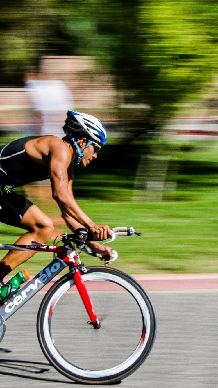 Man in Black Shirt Riding on Red and Black Road Bike. Wallpaper in 750x1334 Resolution