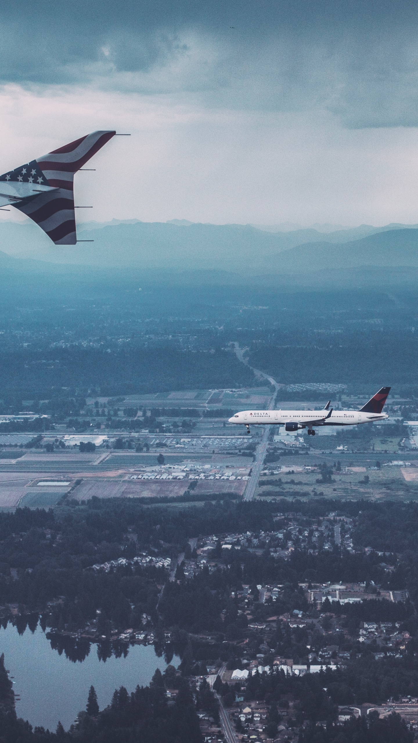 Avion Blanc et Rouge Survolant la Ville Pendant la Journée. Wallpaper in 1440x2560 Resolution