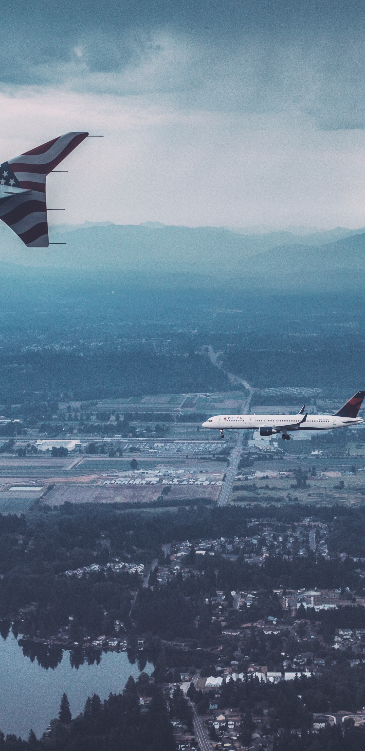 Weißes Und Rotes Flugzeug, Das Tagsüber Über Die Stadt Fliegt. Wallpaper in 1440x2960 Resolution