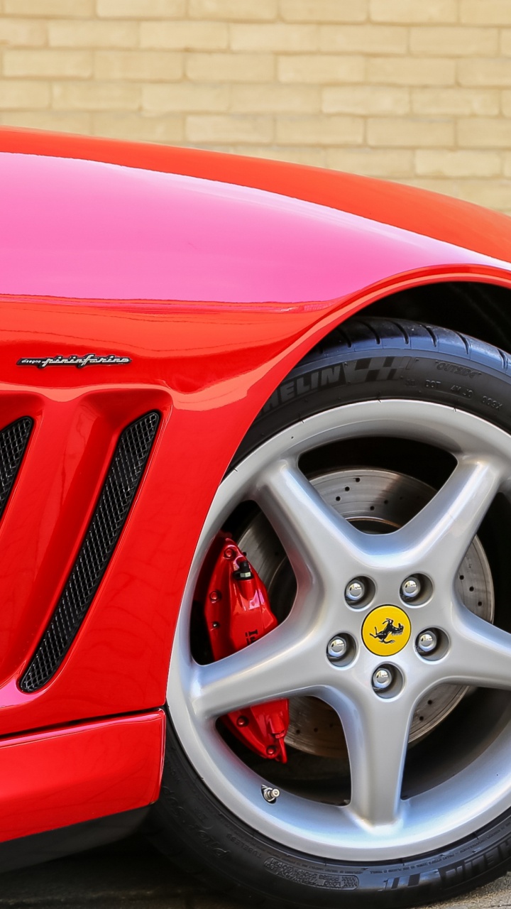 Rotes Auto Geparkt Neben Brauner Backsteinmauer. Wallpaper in 720x1280 Resolution