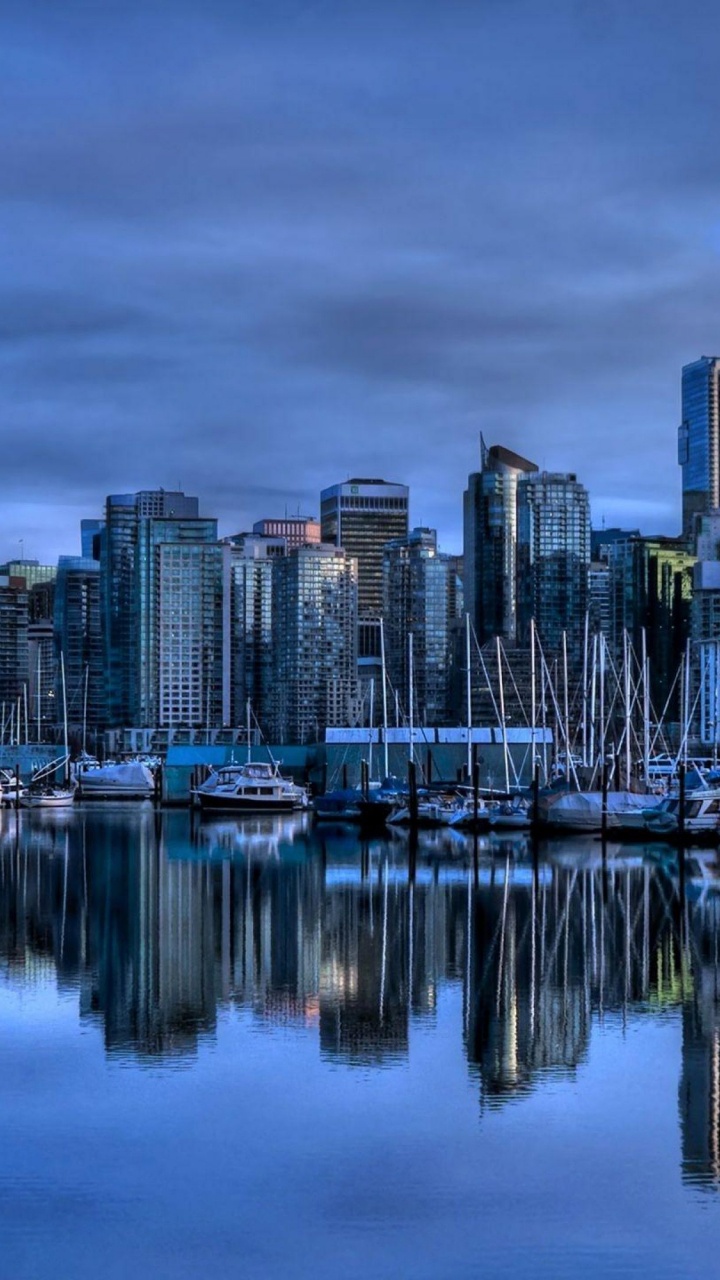 City Skyline Across Body of Water During Night Time. Wallpaper in 720x1280 Resolution