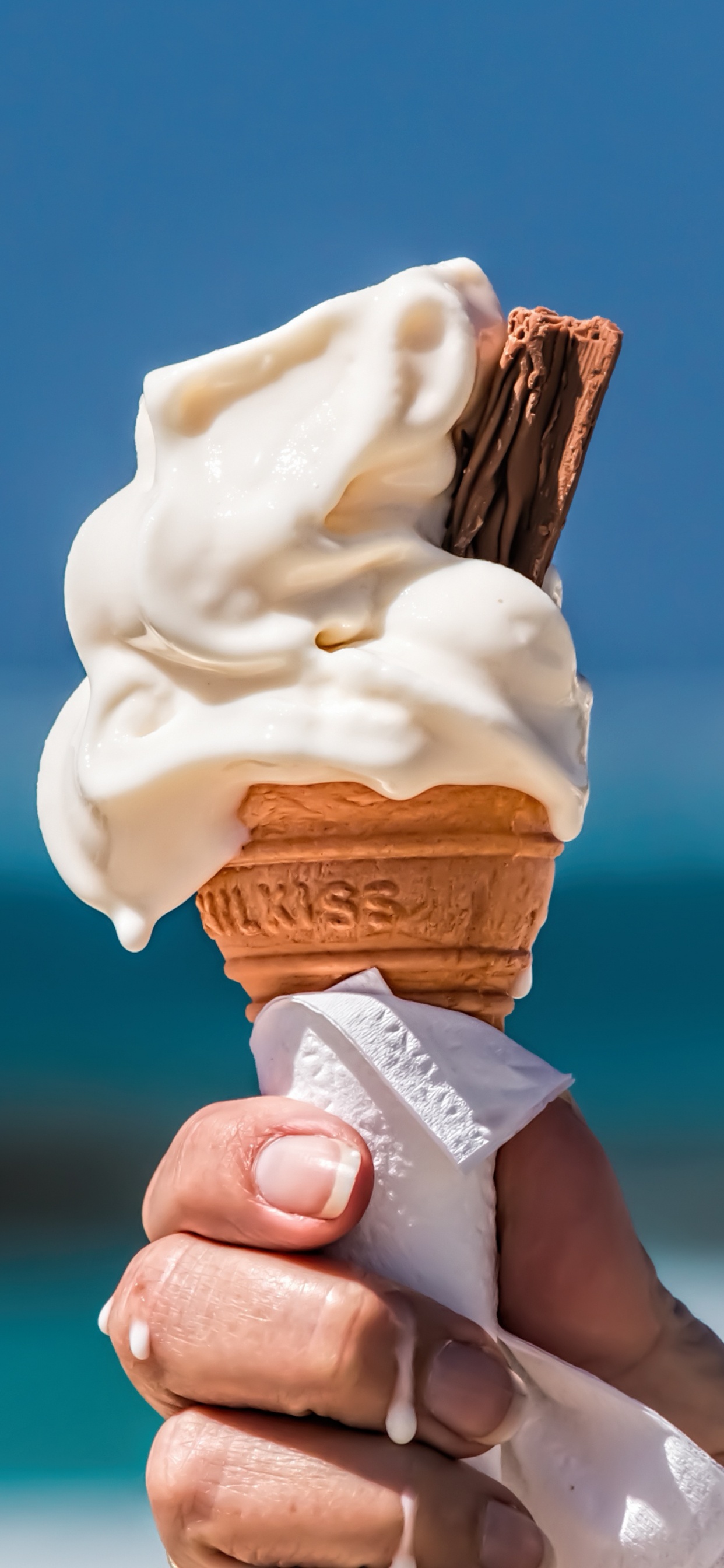 Person Holding Ice Cream Cone. Wallpaper in 1242x2688 Resolution