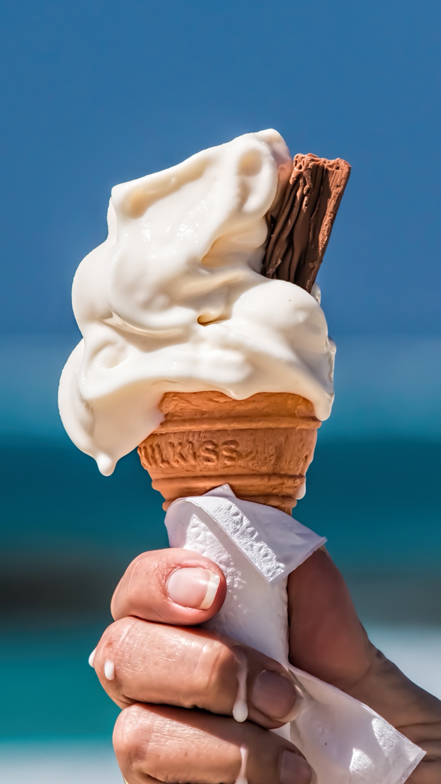Person Holding Ice Cream Cone. Wallpaper in 1440x2560 Resolution