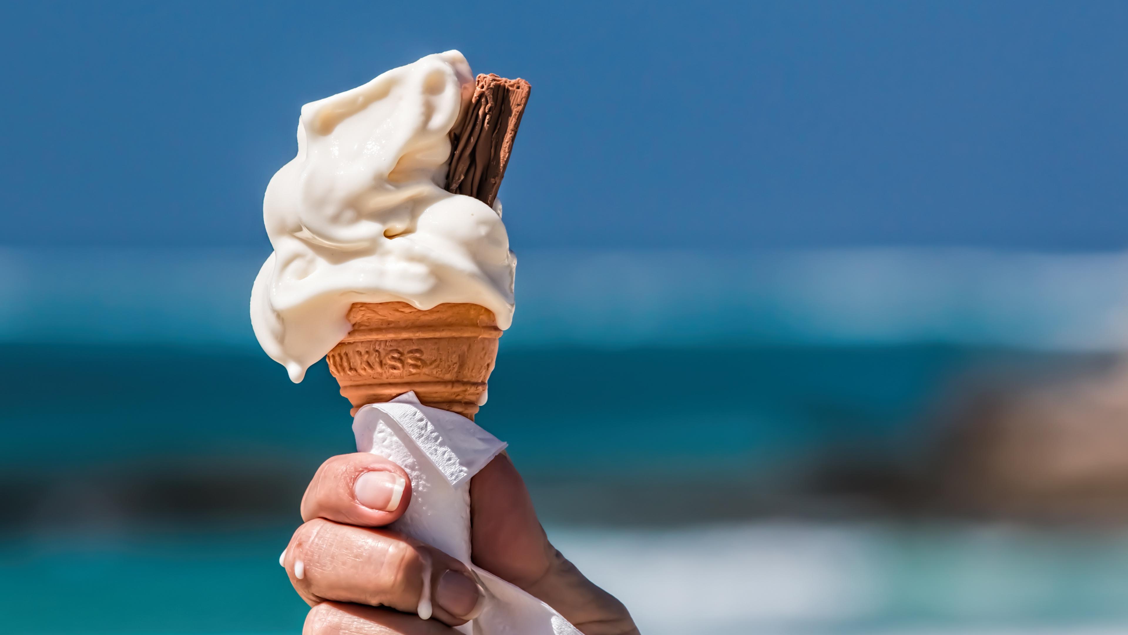 Person Holding Ice Cream Cone. Wallpaper in 3840x2160 Resolution