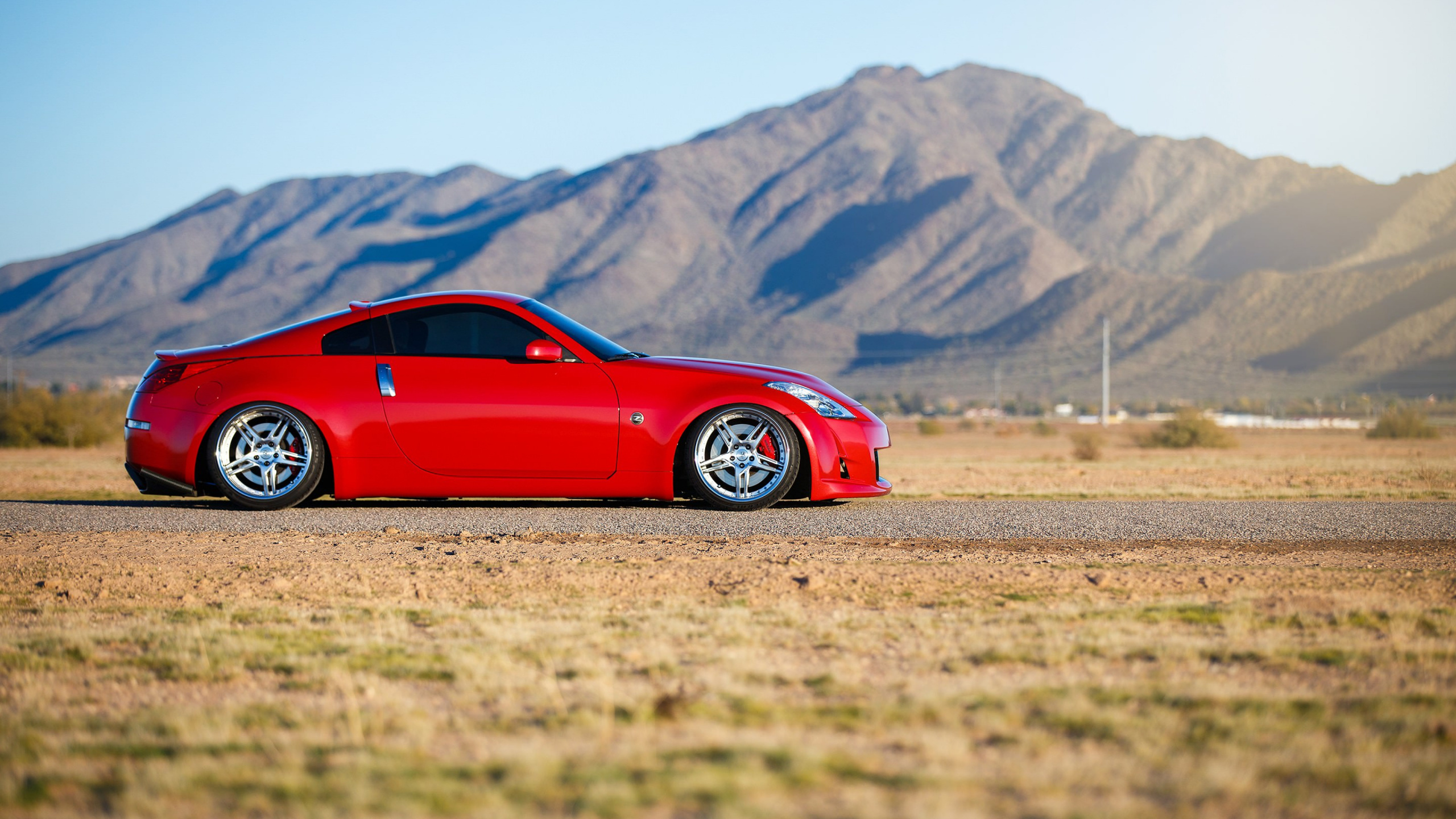 Red Ferrari Coupe on Road During Daytime. Wallpaper in 2560x1440 Resolution