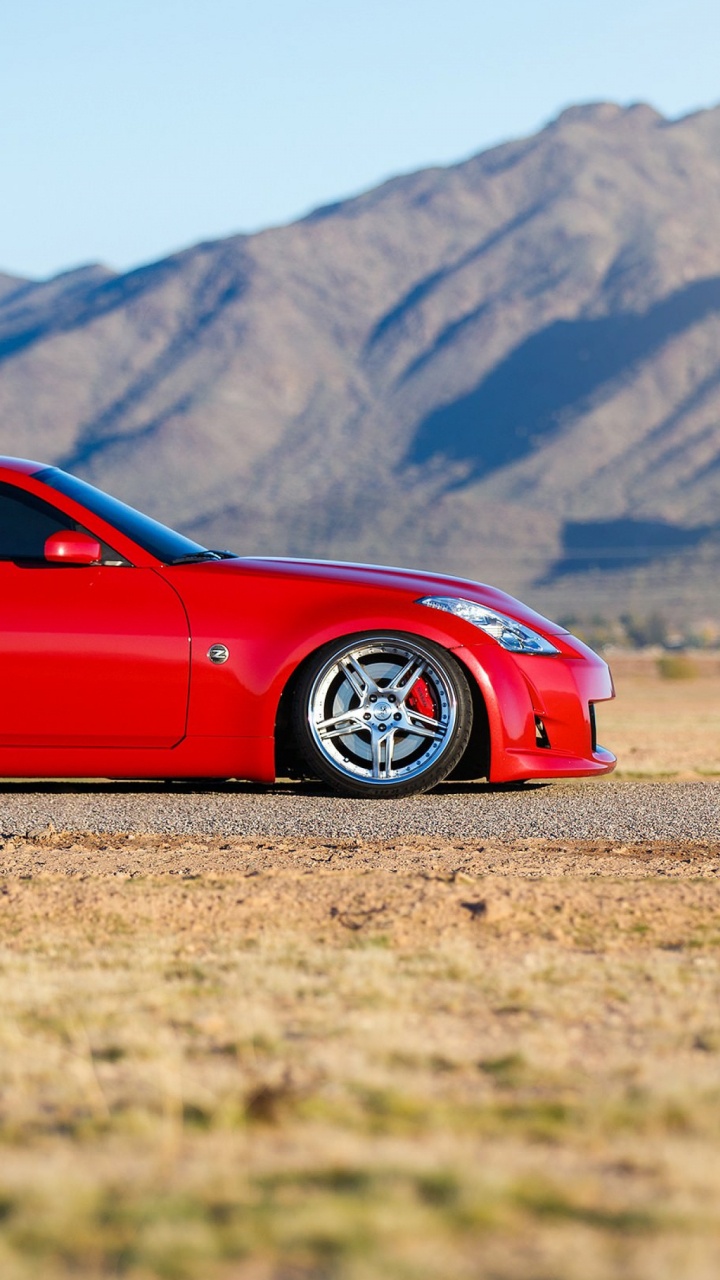 Red Ferrari Coupe on Road During Daytime. Wallpaper in 720x1280 Resolution