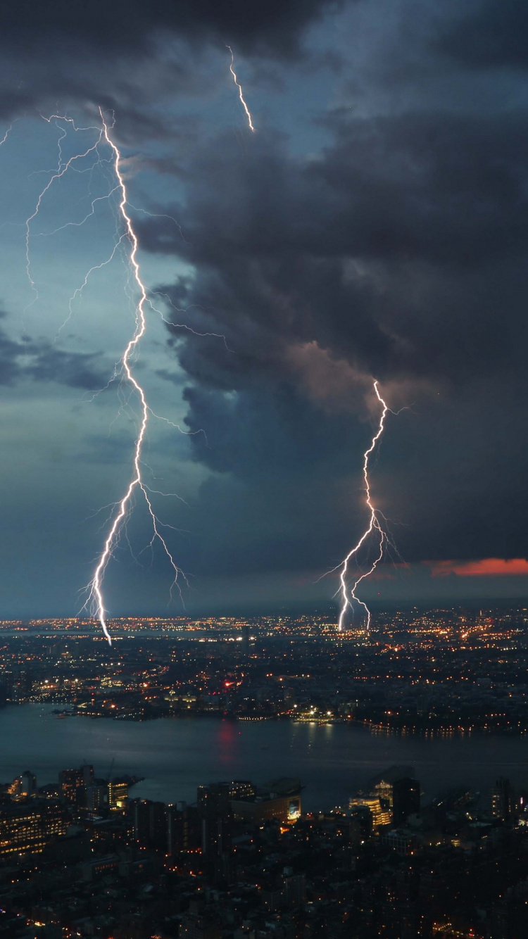 City Skyline Under White Clouds and Blue Sky During Night Time. Wallpaper in 750x1334 Resolution