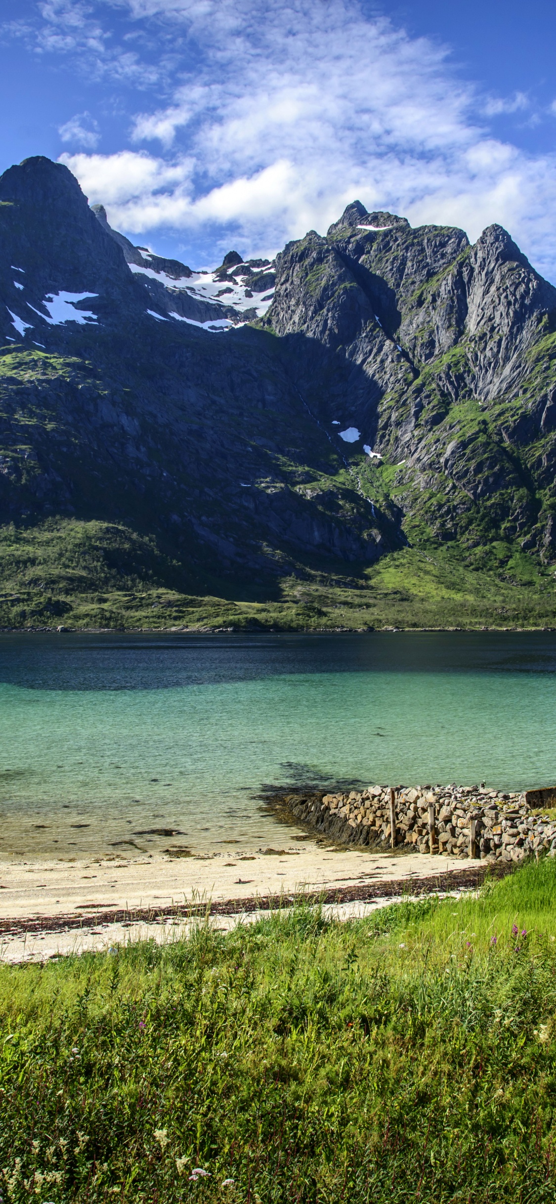 Brown Wooden House Near Body of Water and Mountain During Daytime. Wallpaper in 1125x2436 Resolution