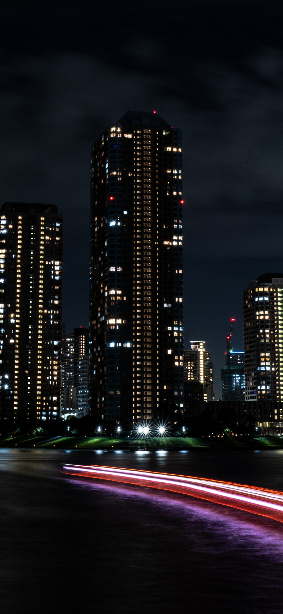 City Skyline During Night Time. Wallpaper in 1125x2436 Resolution